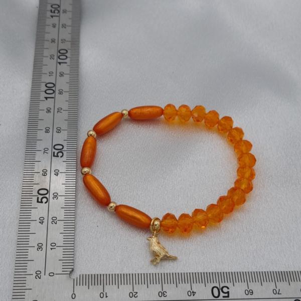 Handgemaakte armband met vergulde bedel - oranje