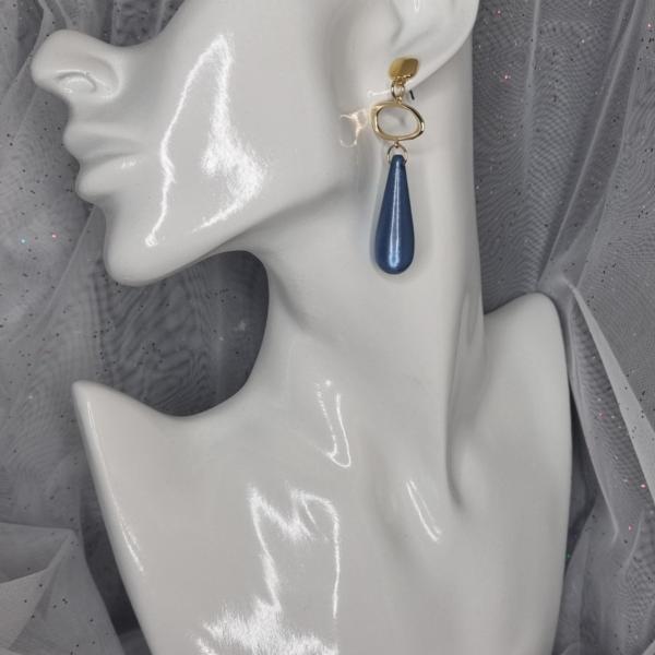 Vergulde statement oorbellen met polaris - blauw